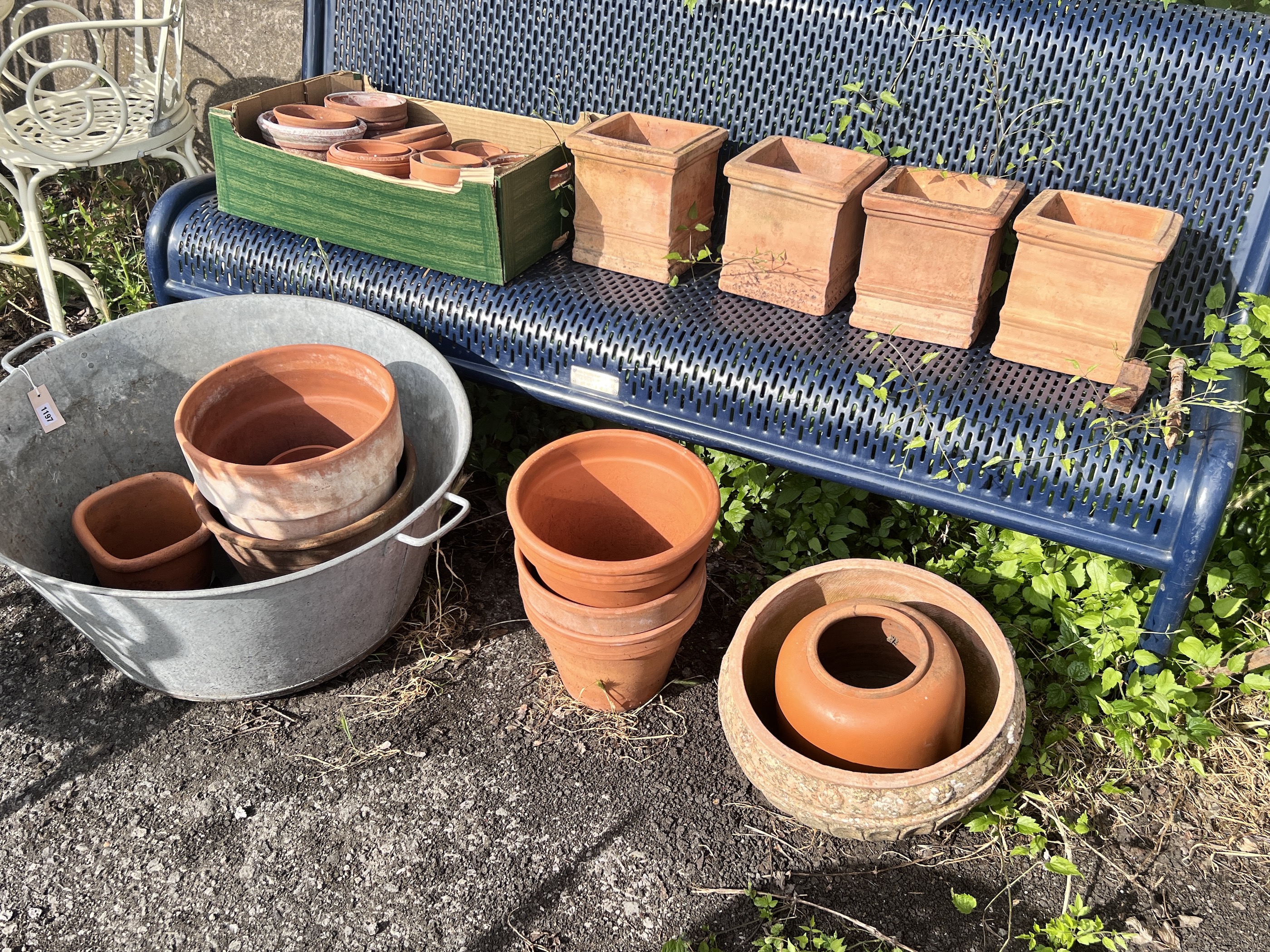 A large circular galvanised tub, diameter 72cm, together with a quantity of assorted terracotta garden pots